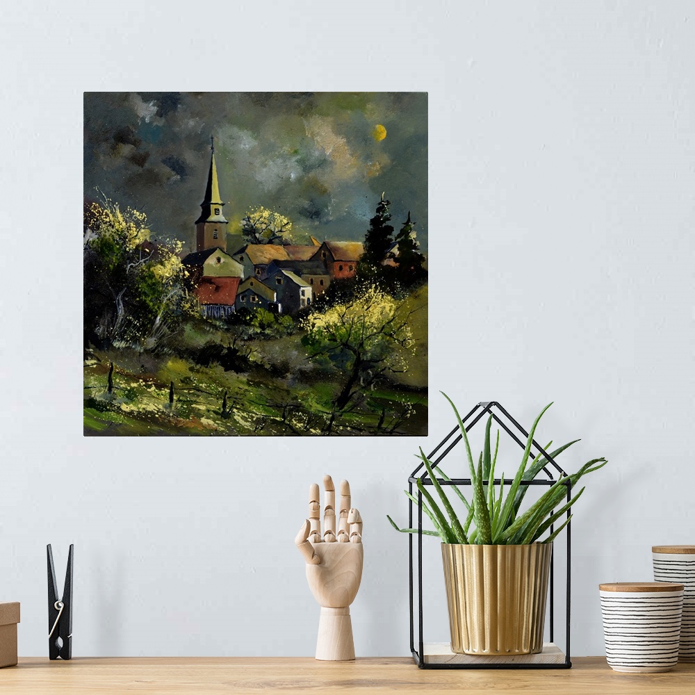 A bohemian room featuring Square painting of a darkened landscape with a field in the foreground and a Belgium village in t...
