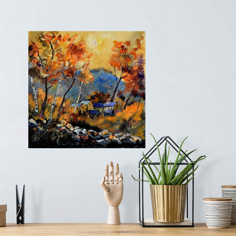 A bohemian room featuring Vibrant painting of a fall day with golden trees, a colorful sky, and a village in the distance.