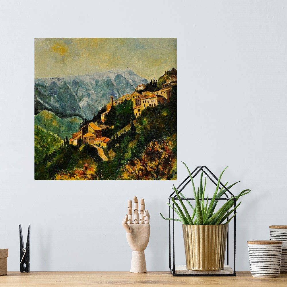 A bohemian room featuring Landscape painting of the village of Brantes in France on a hill side with mountains near by and ...