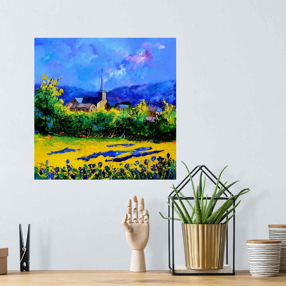 A bohemian room featuring Vibrant painting of a bright day with blossoming trees, a colorful sky, and a village in the dist...