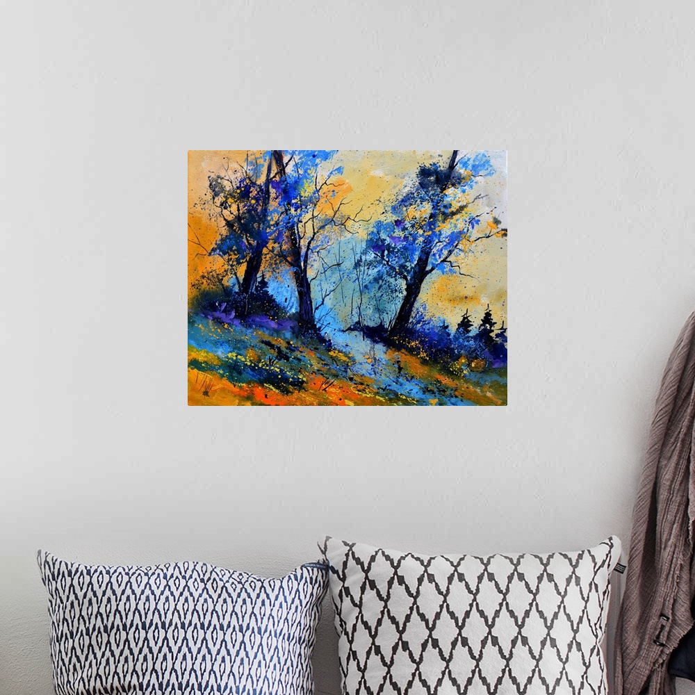 A bohemian room featuring Vibrant painting of blue leaved trees, a colorful sky, and orange grass in the foreground.