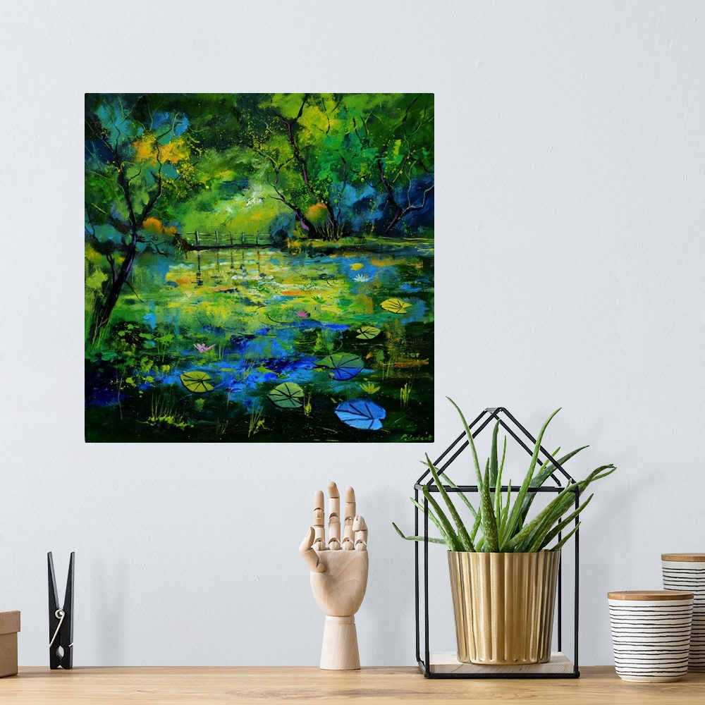 A bohemian room featuring Impressionist painting of a blue, green, and yellow toned pond covered with lily pads and waterli...