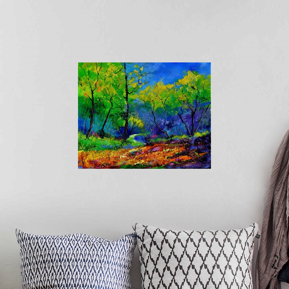 A bohemian room featuring Vibrant painting of a colorful path through a forest of green leaved trees and a bright blue sky.