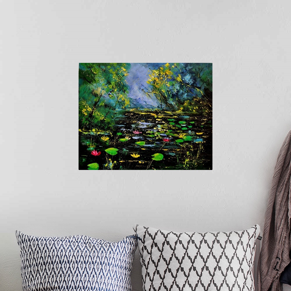A bohemian room featuring Landscape painting of green lily pads in a dark colored pond framed by vibrant green trees.