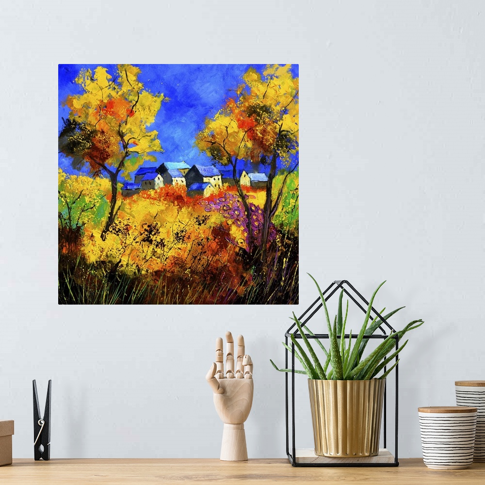 A bohemian room featuring Square painting of a summer landscape with a colorful field in the foreground and a Belgium villa...
