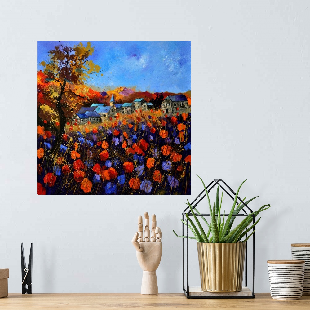 A bohemian room featuring Vibrant painting of a fall day with blossoming flowers, a colorful sky, and a village in the dist...