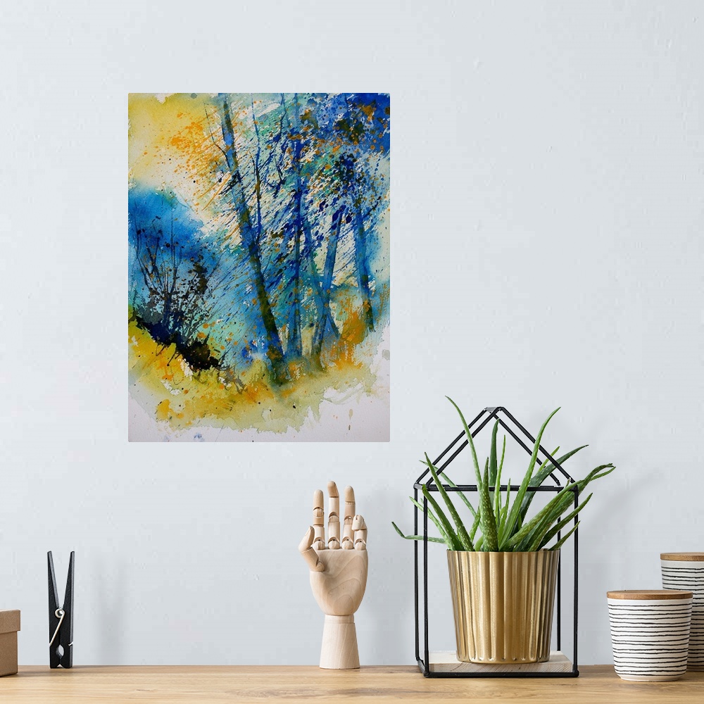 A bohemian room featuring A vertical watercolor landscape of trees in bright colors of yellow and blue.