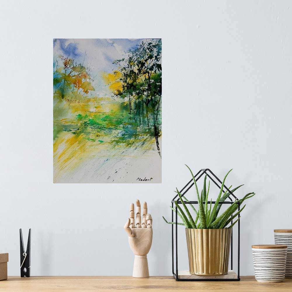 A bohemian room featuring A vertical watercolor landscape in bright colors of yellow, green and blue.