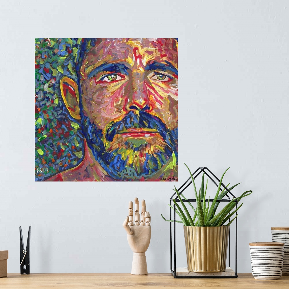 A bohemian room featuring I Am Bear by RD Riccoboni. A man with a beard and green eyes.