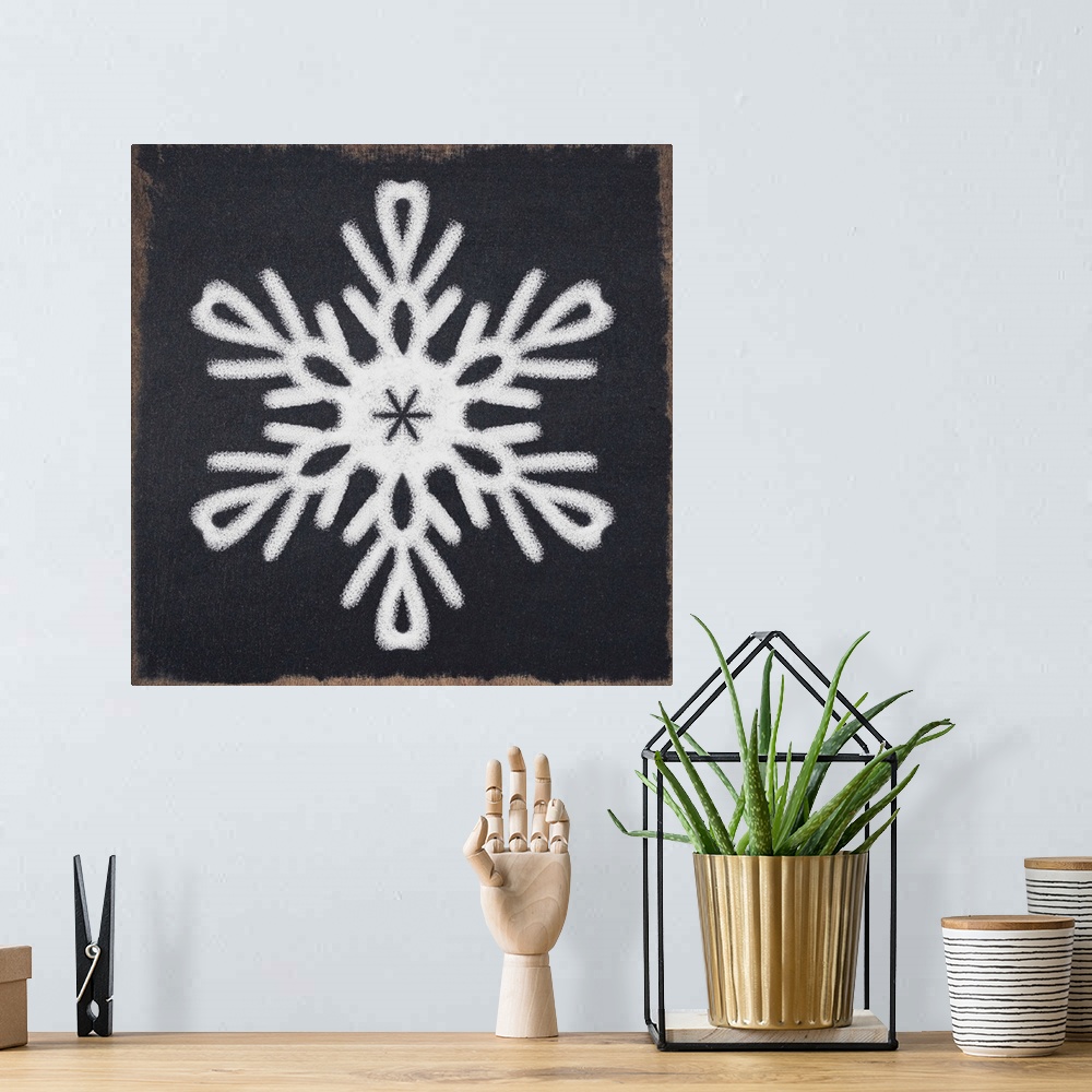 A bohemian room featuring Square illustration of a white snowflake on a black chalkboard background.