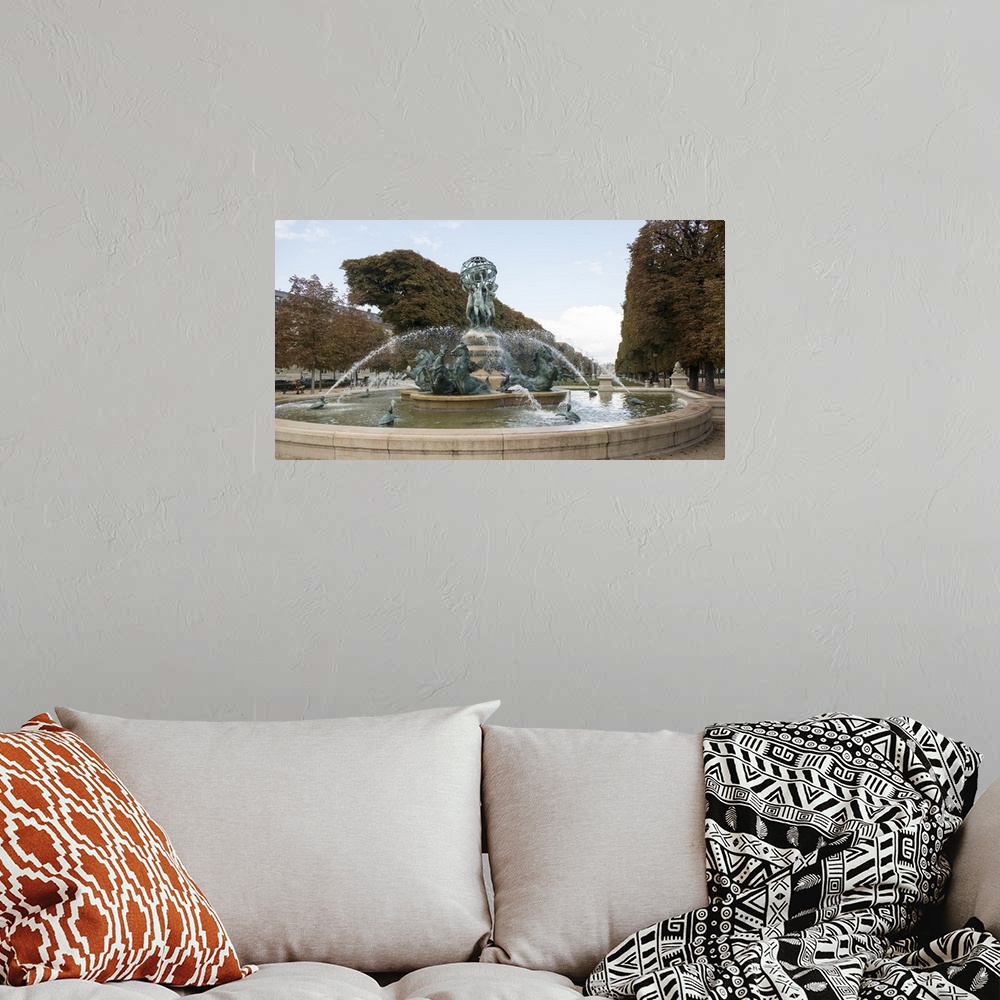 A bohemian room featuring Photograph of the Fountain Of The Observatory in Paris, France.