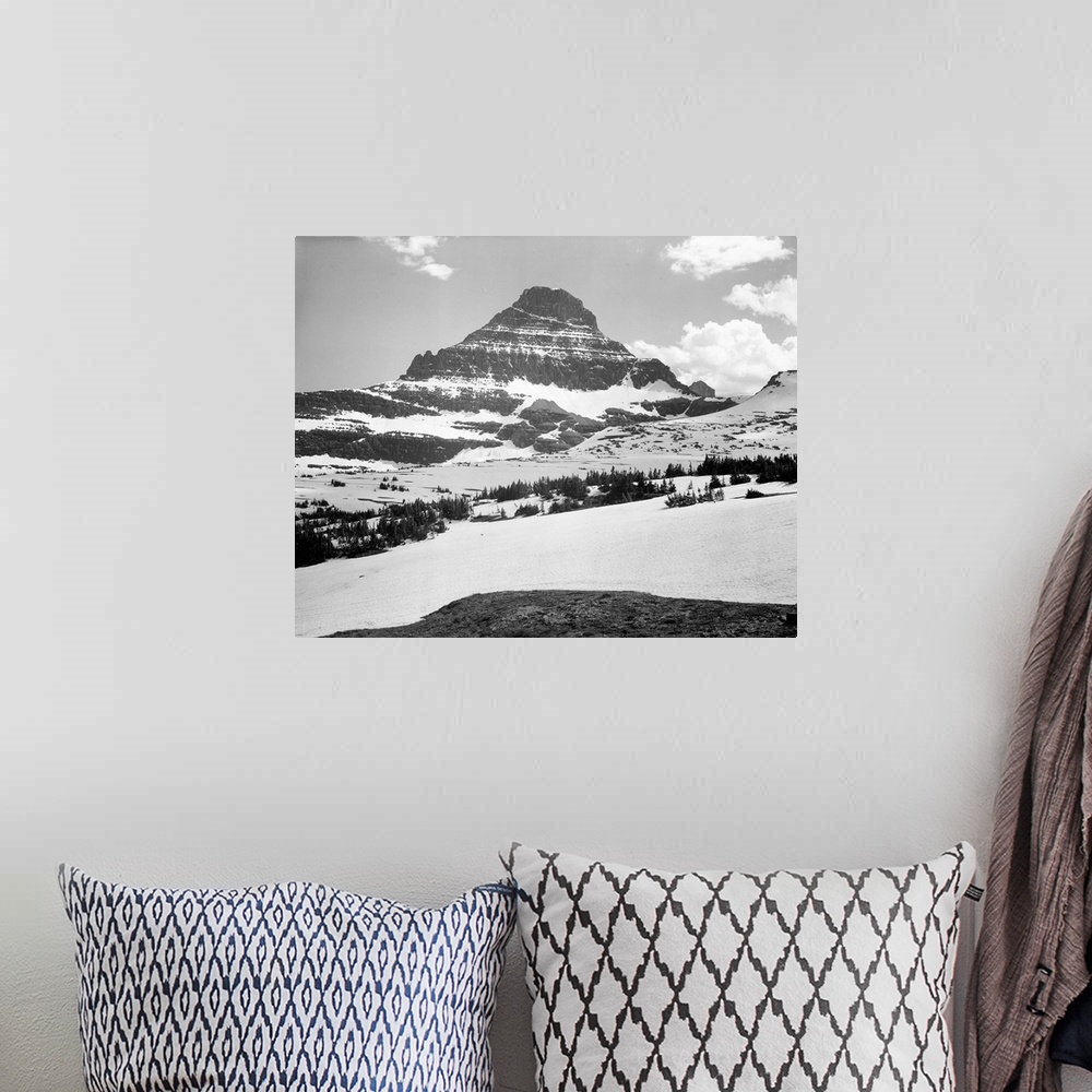 A bohemian room featuring From Logan Pass, Glacier National Park, looking across barren land to mountains.