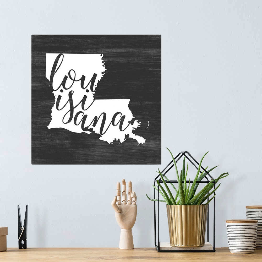 A bohemian room featuring Louisiana state outline typography artwork.