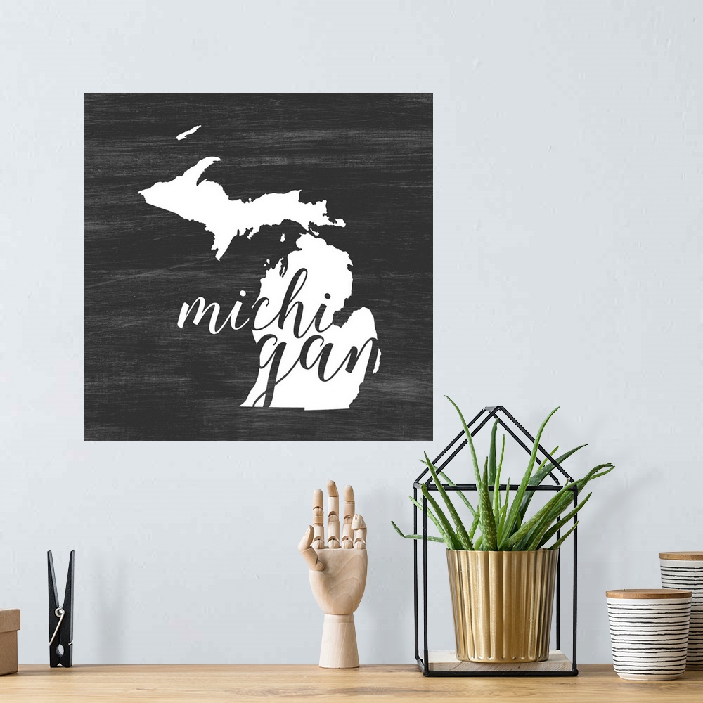 A bohemian room featuring Michigan state outline typography artwork.