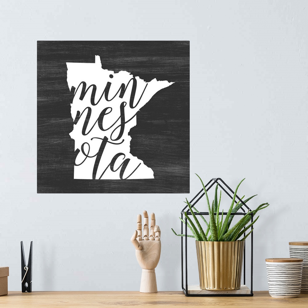 A bohemian room featuring Minnesota state outline typography artwork.