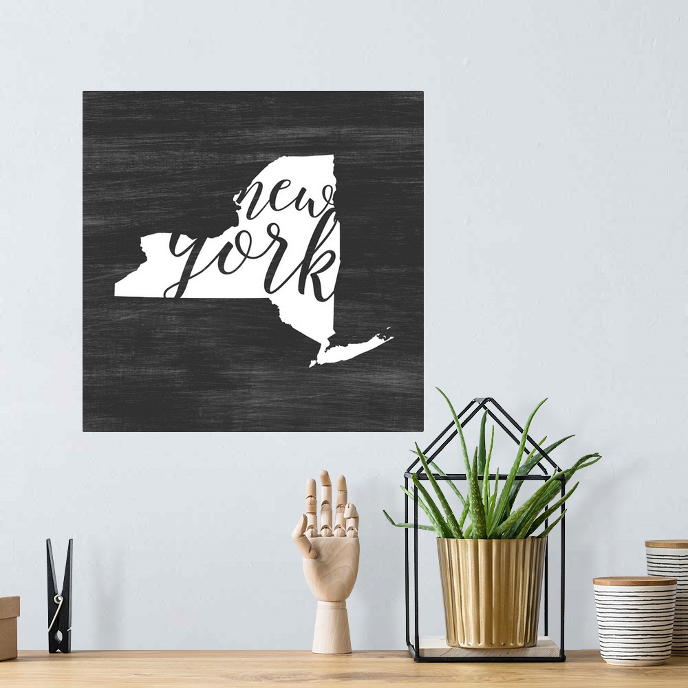 A bohemian room featuring New York state outline typography artwork.