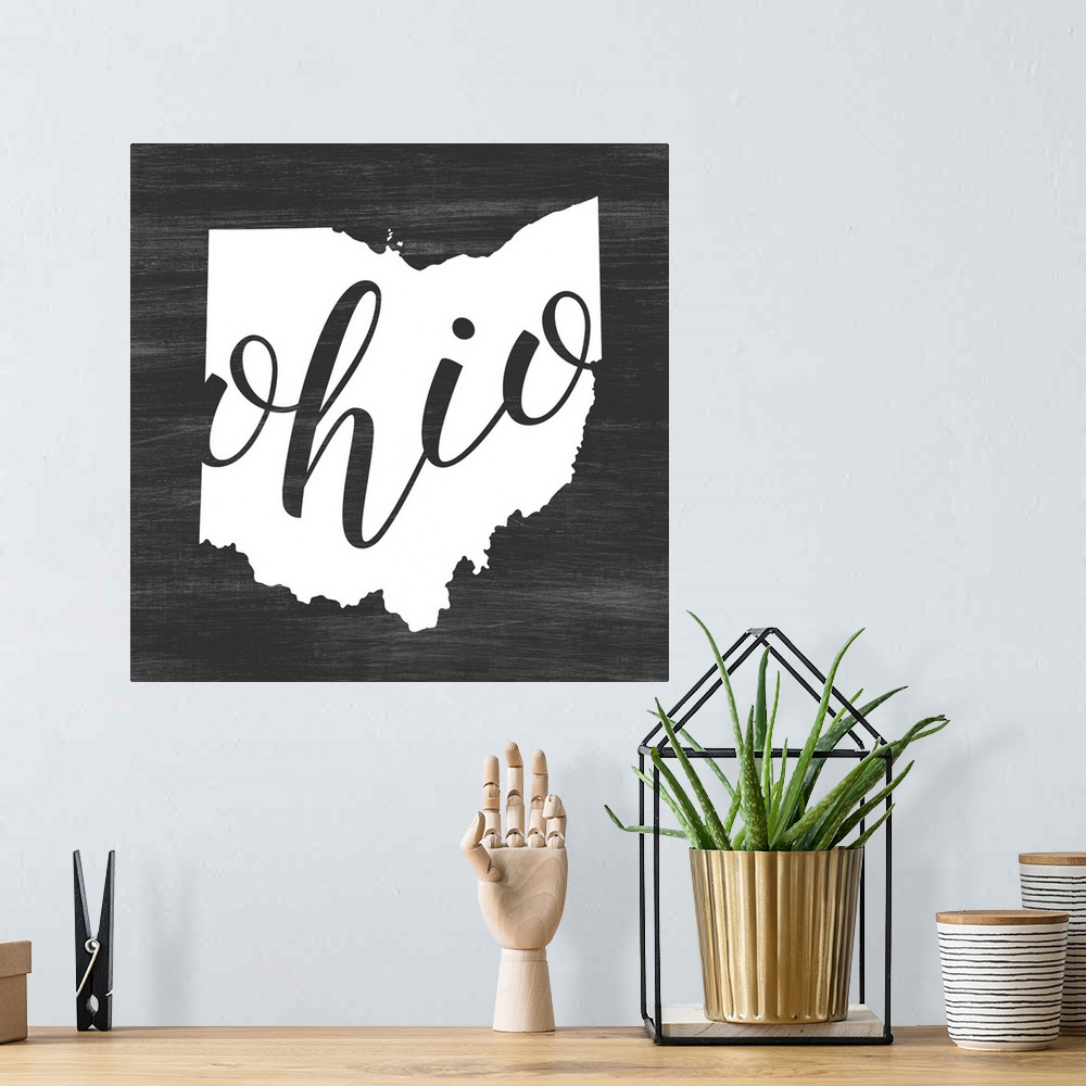 A bohemian room featuring Ohio state outline typography artwork.