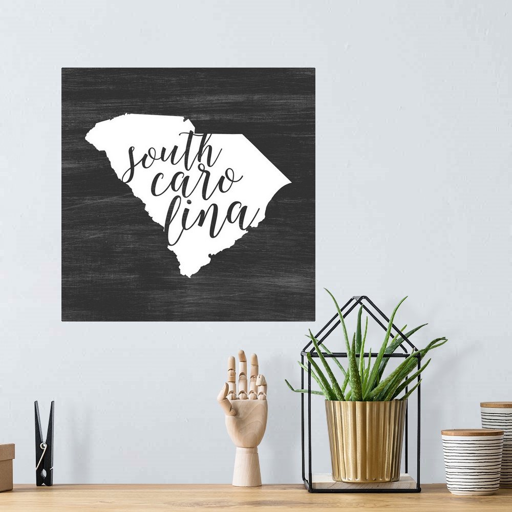 A bohemian room featuring South Carolina state outline typography artwork.