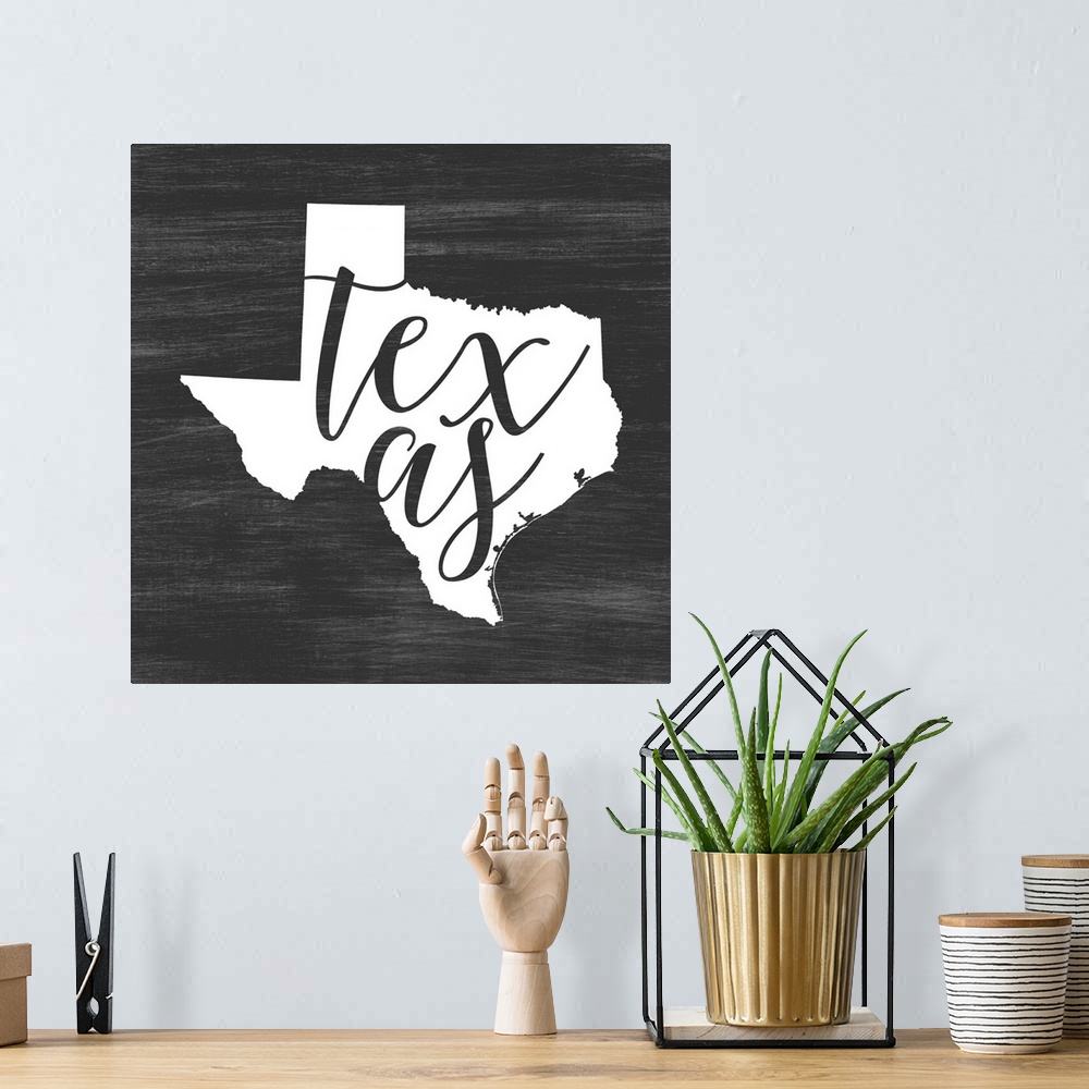 A bohemian room featuring Texas state outline typography artwork.