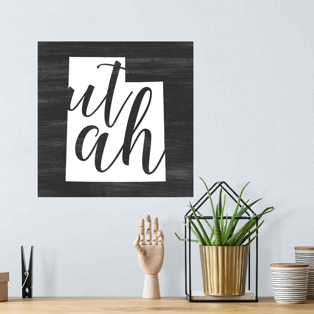 A bohemian room featuring Utah state outline typography artwork.