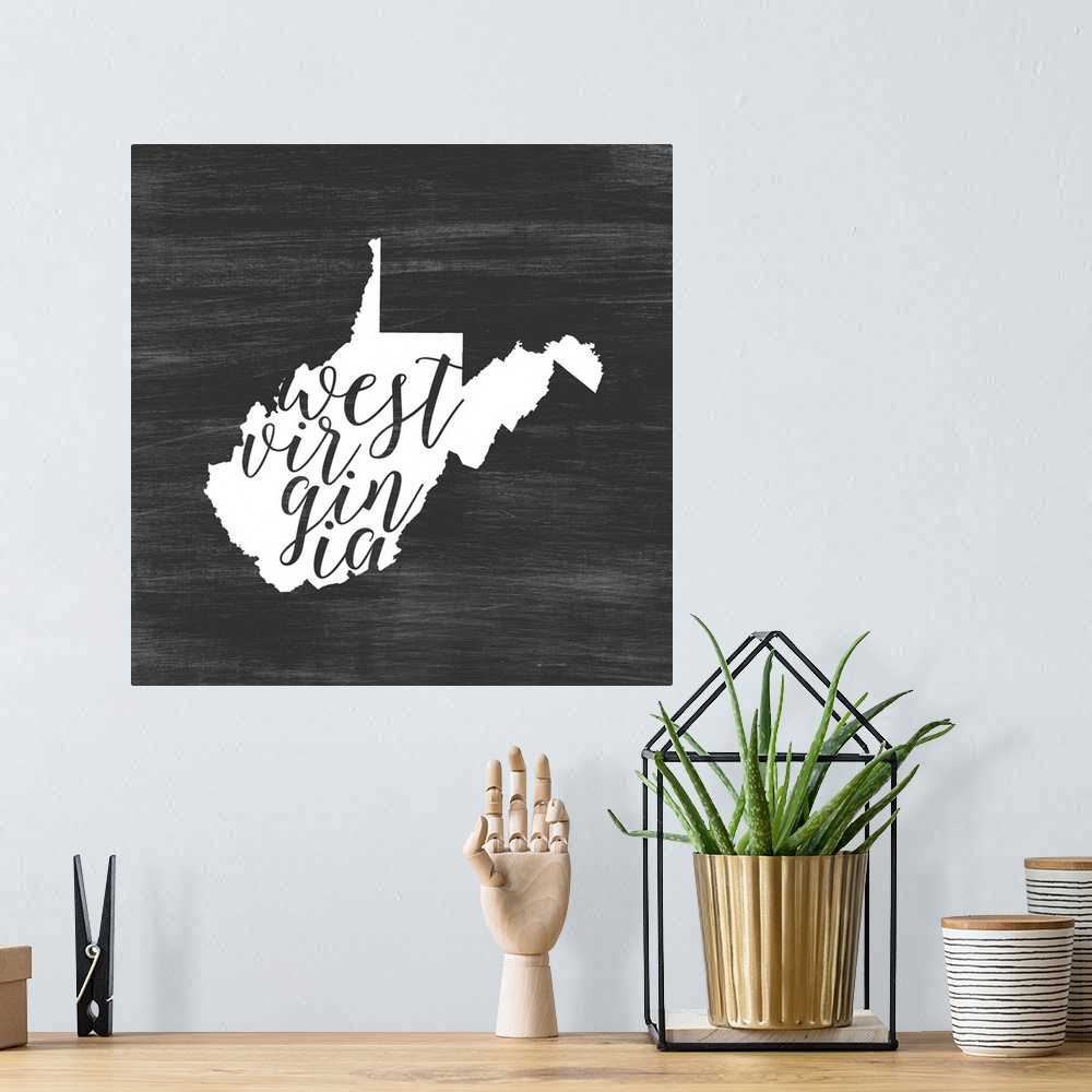 A bohemian room featuring West Virginia state outline typography artwork.