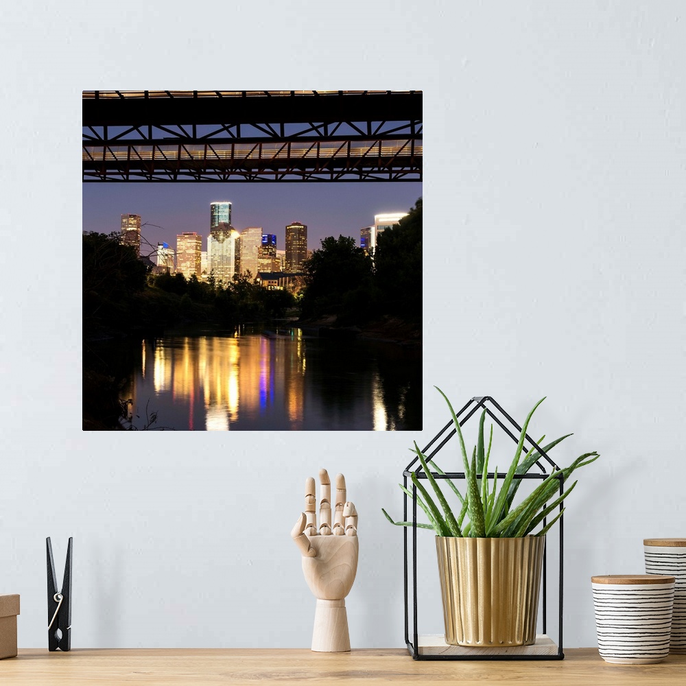 A bohemian room featuring Square photograph of the Houston TX skyline at night reflecting into the Buffalo Bayou with the R...