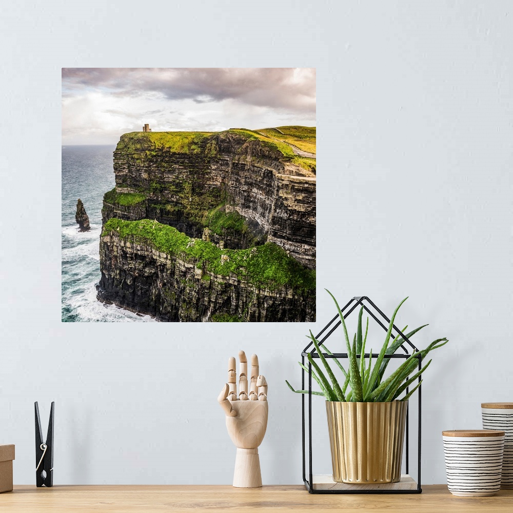 A bohemian room featuring Square photograph of O'Brien's Tower, marking the highest point of the Cliffs of Moher in Ireland.