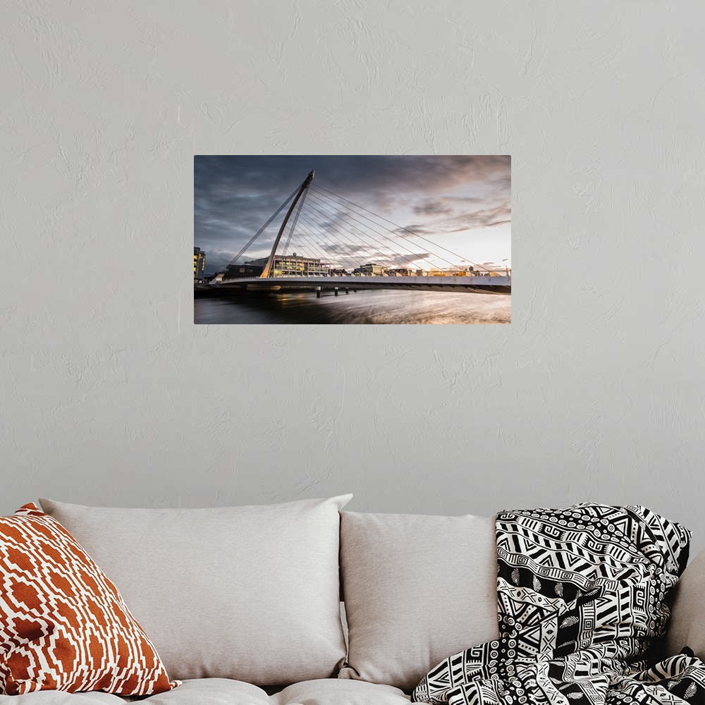 A bohemian room featuring Panoramic photograph of the Samuel Beckett Bridge, a cable-stayed bridge in Dublin, Ireland going...