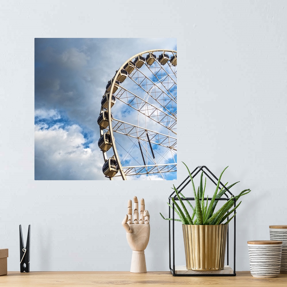 A bohemian room featuring The gondolas of SkyView Atlanta Ferris Wheel, a 20-story wheel, against a backdrop of clouds over...