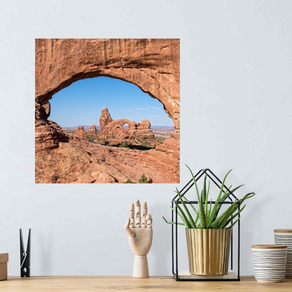 A bohemian room featuring The Turret Arch seen through the North Window Arch, on Windows hiking trail, Arches national Park...