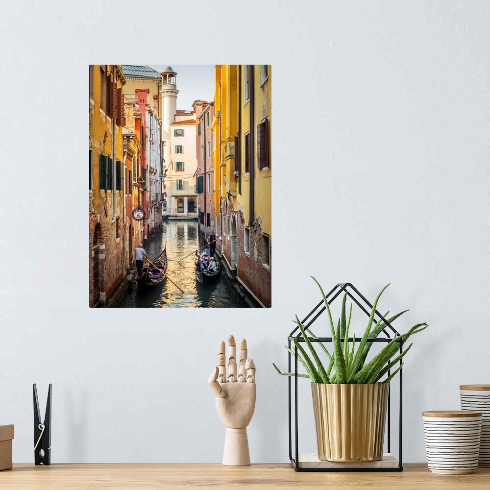 A bohemian room featuring Photograph of two gondolas passing each other through a canal lined with yellow and red buildings...