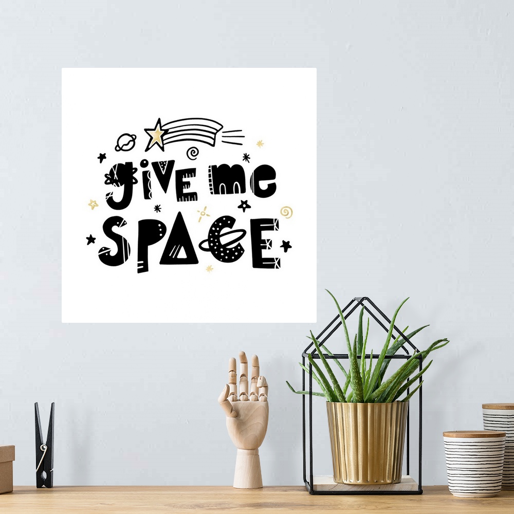 A bohemian room featuring "Give Me Space" in an artistic font with stars and planets on a white background and gold accents.
