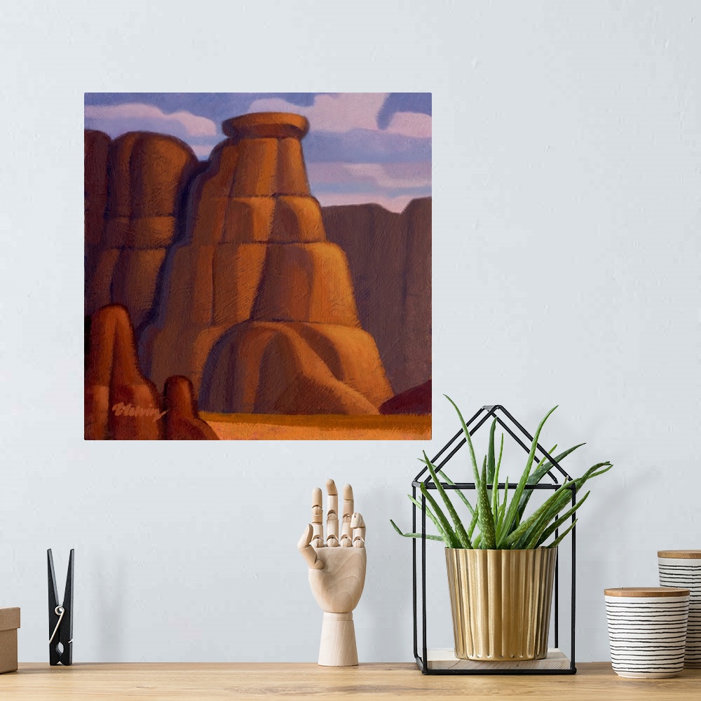 A bohemian room featuring Landscape painting of red rock canyon and cliffs.