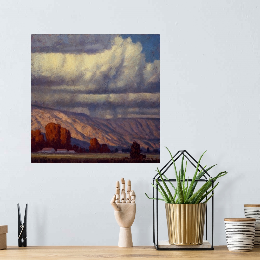 A bohemian room featuring Landscape painting of a mountain valley with the rain clouds of September.