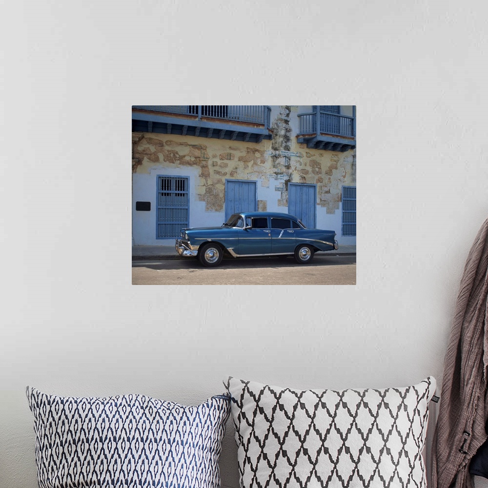 A bohemian room featuring An old blue Chevrolet car parked in a street in Old Havana, Cuba, Caribbean