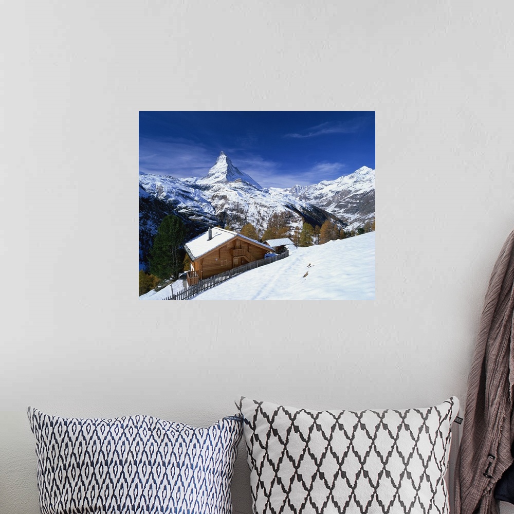 A bohemian room featuring Chalets in a snowy landscape with the Matterhorn peak, Swiss Alps, Switzerland