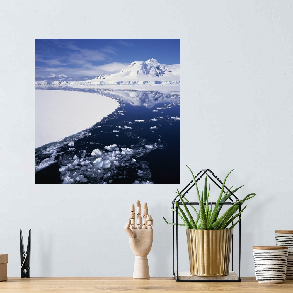 A bohemian room featuring Reflections in icy sea of snow covered mountain, Antarctica