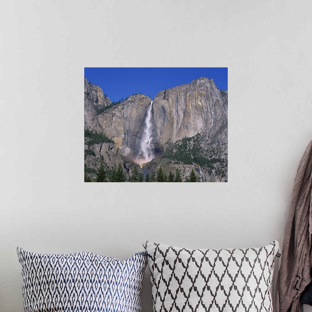 A bohemian room featuring Waterfall cascades over rock wall at Rainbow Falls in the Yosemite Park, California