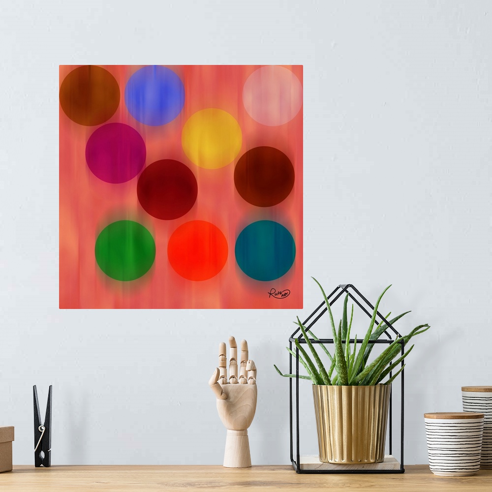 A bohemian room featuring Square abstract art with a pink background and faded falling circles in different colors.