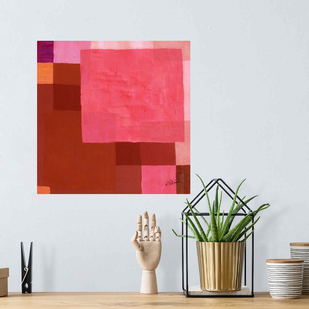 A bohemian room featuring Square abstract painting with layered geometric squares in shades of pink and red.