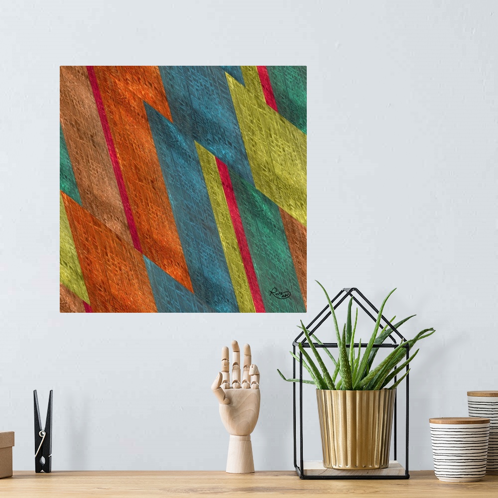 A bohemian room featuring Square abstract artwork in shades of orange, blue and green in a diagonal striped design.