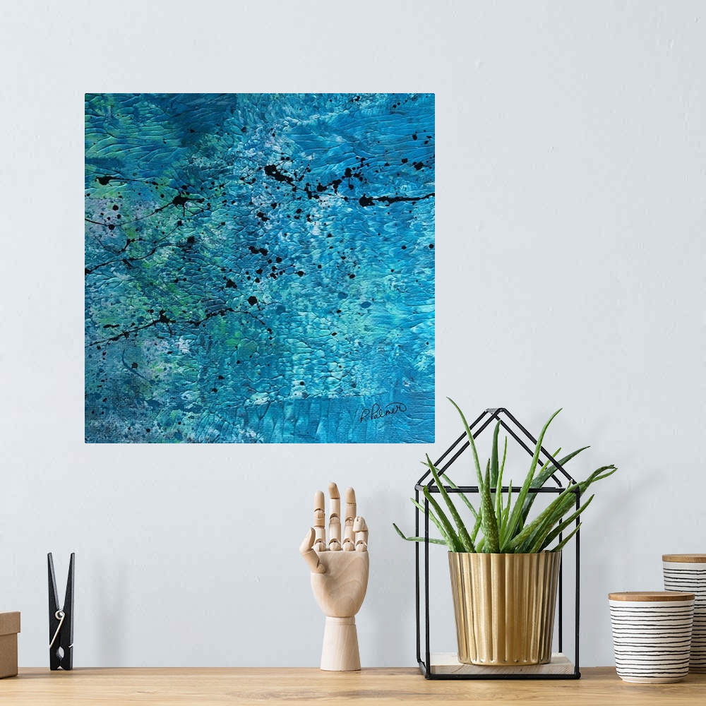 A bohemian room featuring Square abstract painting with a blue, white, and green textured background with black paint splat...