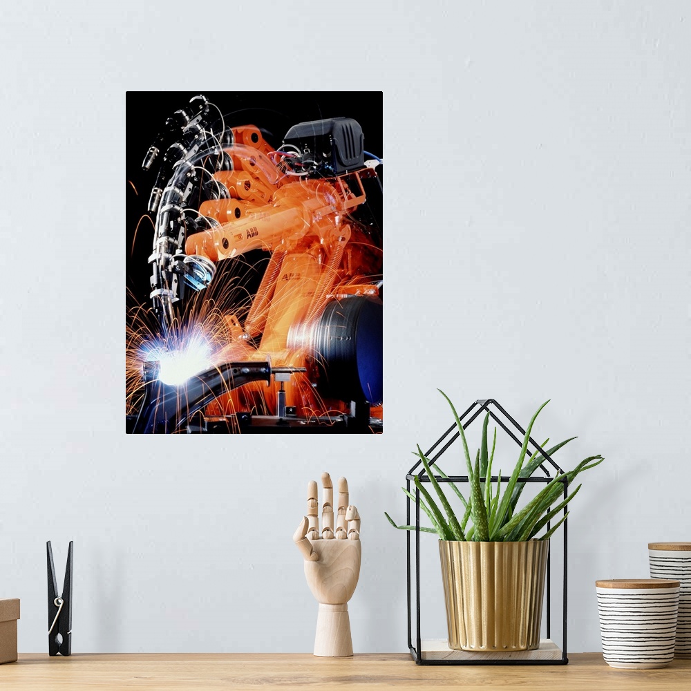 A bohemian room featuring Robot welding in car production. Multiple exposure image of a robot arm spot-welding the suspensi...