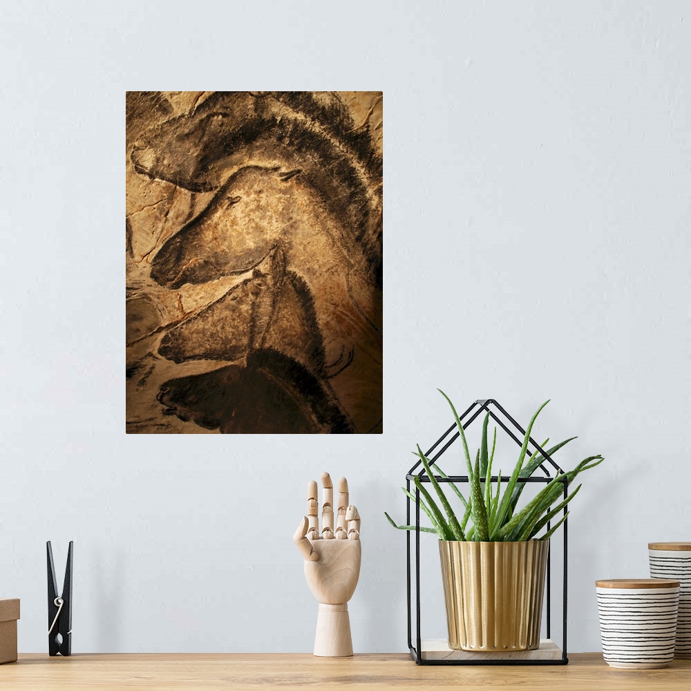 A bohemian room featuring Stone-age cave paintings. Artwork of horses painted on the wall of a cave. These paintings are fo...