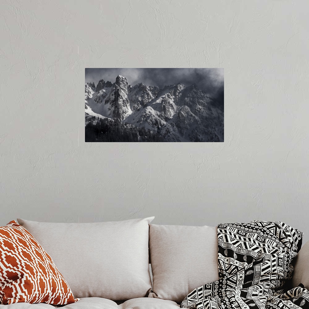 A bohemian room featuring Black and white photograph of a snowy Mont Blanc on a hazy day.