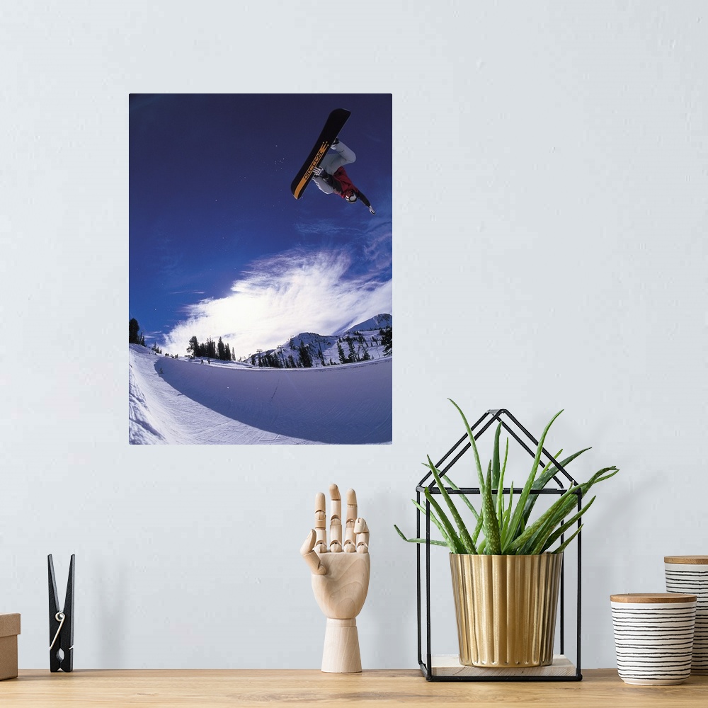 A bohemian room featuring Scott Eckhard performing a straight air jump at Mammoth Mountain Ski Area, California.