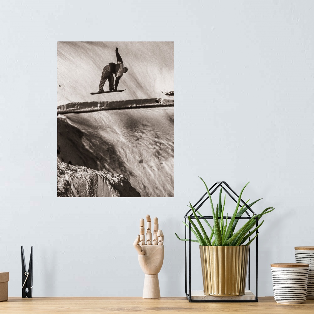 A bohemian room featuring Black and white image of Tracy Latzen grabbing his snowboard in hte air at Donner Summit, Califor...