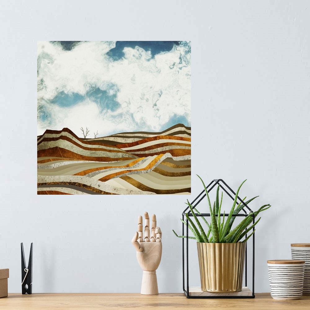A bohemian room featuring Abstract depiction of a desert scene with bronze, gold, textures and blue sky.