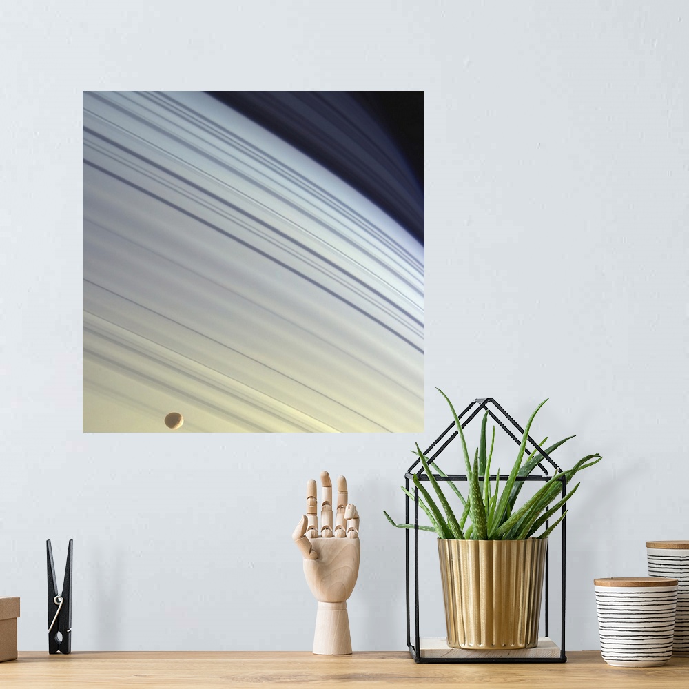 A bohemian room featuring Mimas drifts along in its orbit against the azure backdrop of Saturns northern latitudes