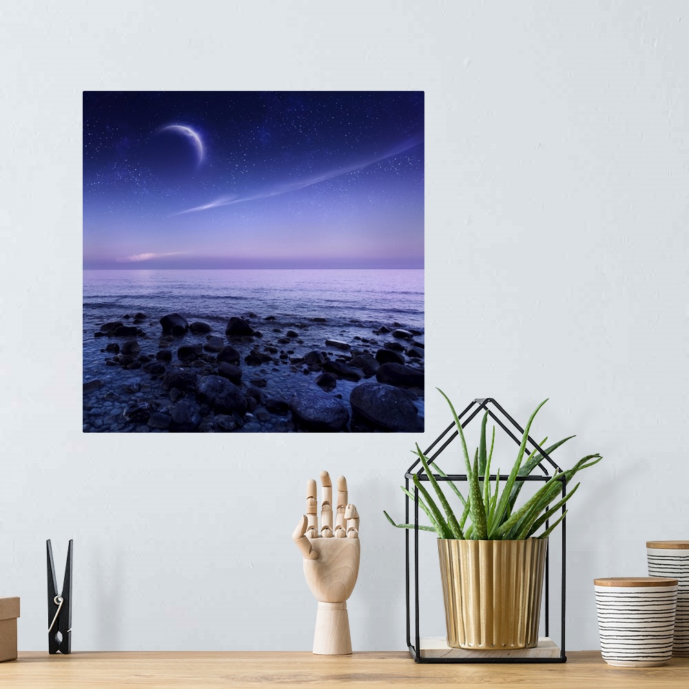 A bohemian room featuring Moon rising over rocky seaside against starry sky.
